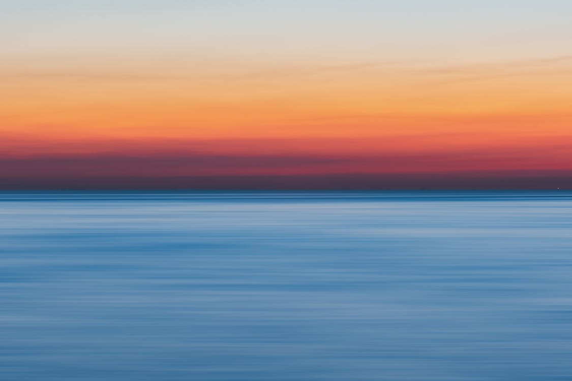 Calm golden hour water representing nervous system stability before a psilocybin ceremony